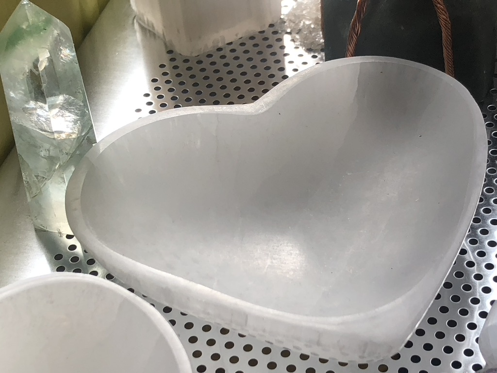 Selenite Heart shaped trinket bowl on a stainless steel metal background
