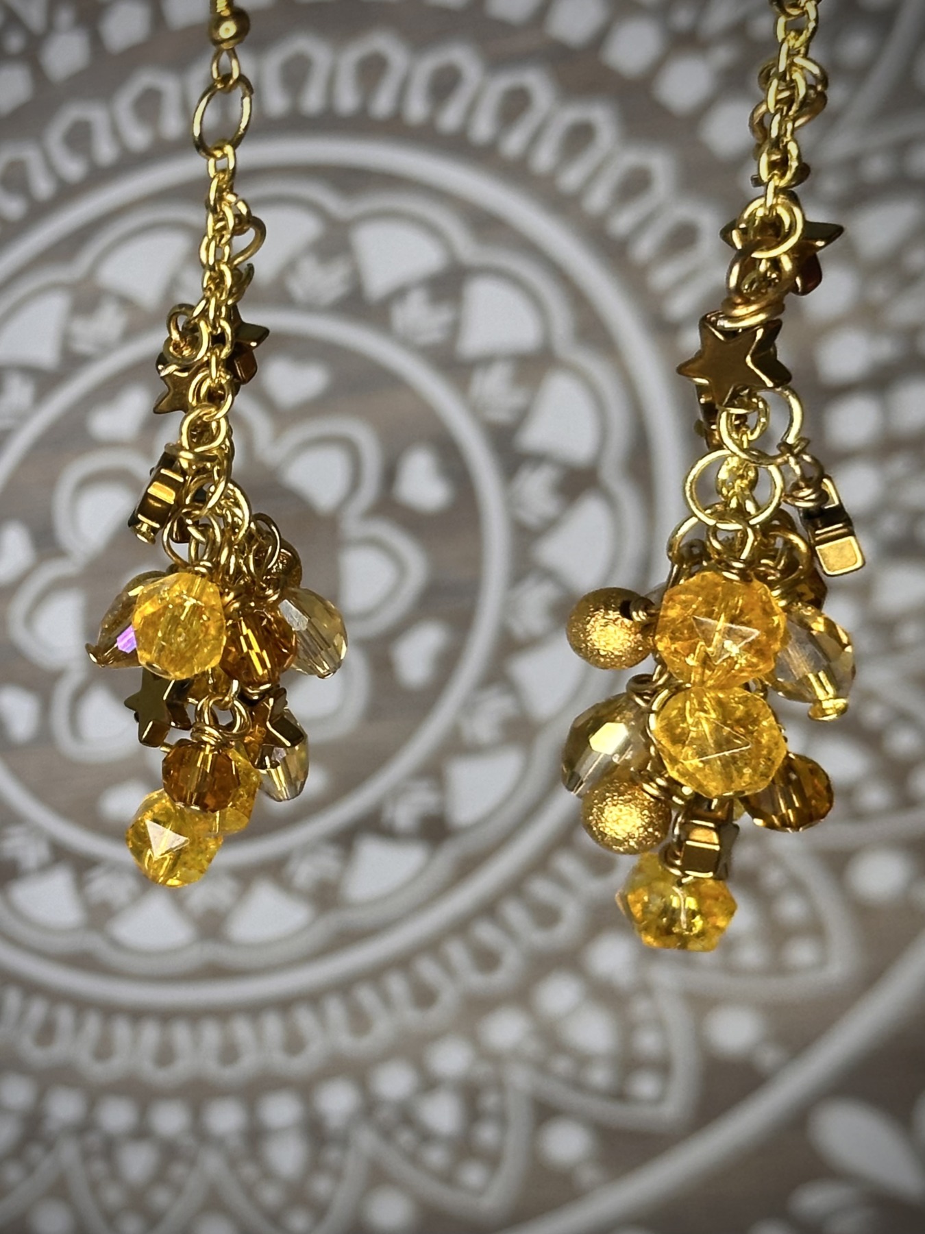 A pair of Solar Flare Cascade Earrings featuring an elegant celestial design with intricate details