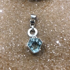 Sterling silver pendant featuring a faceted pentagon-shaped clear volcanic obsidian and a small marquise-cut black obsidian accent on a silver link detail.
