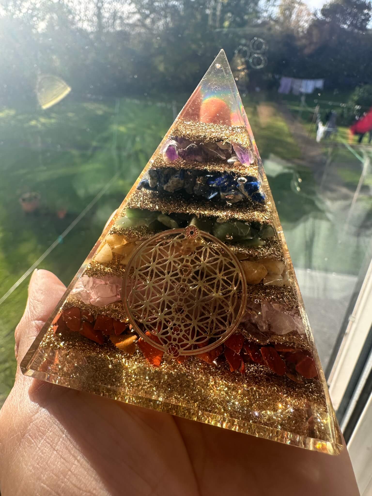 Seven chakra orgonite pyramid with flower of life design for full-body energy balancing and healing