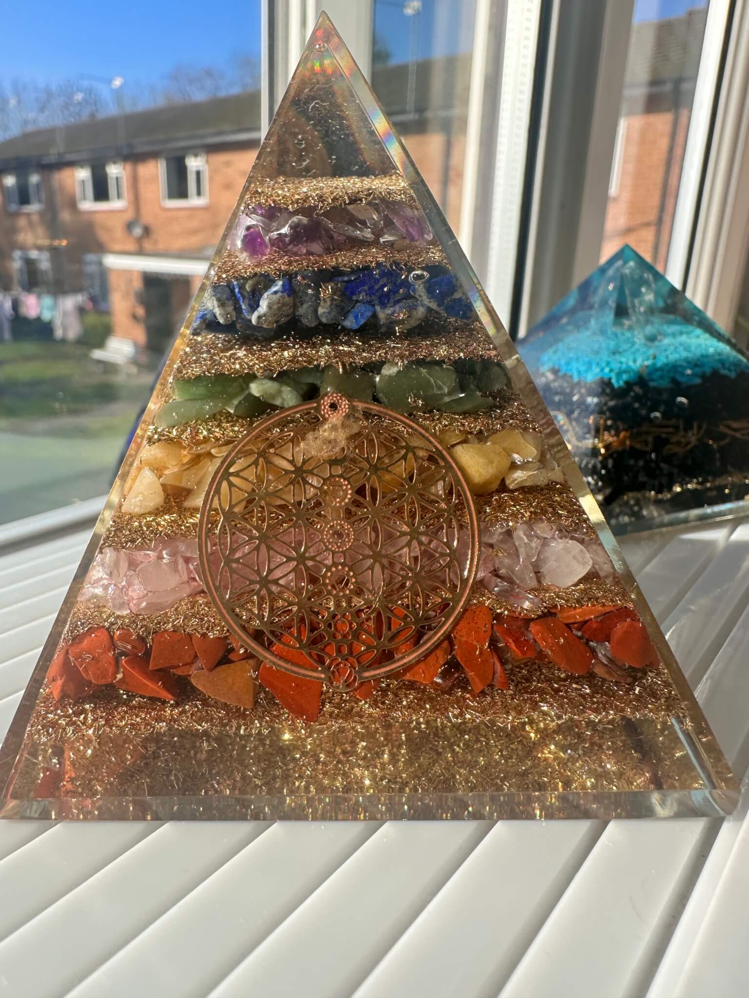 Seven chakra orgonite pyramid with flower of life design for full-body energy balancing and healing