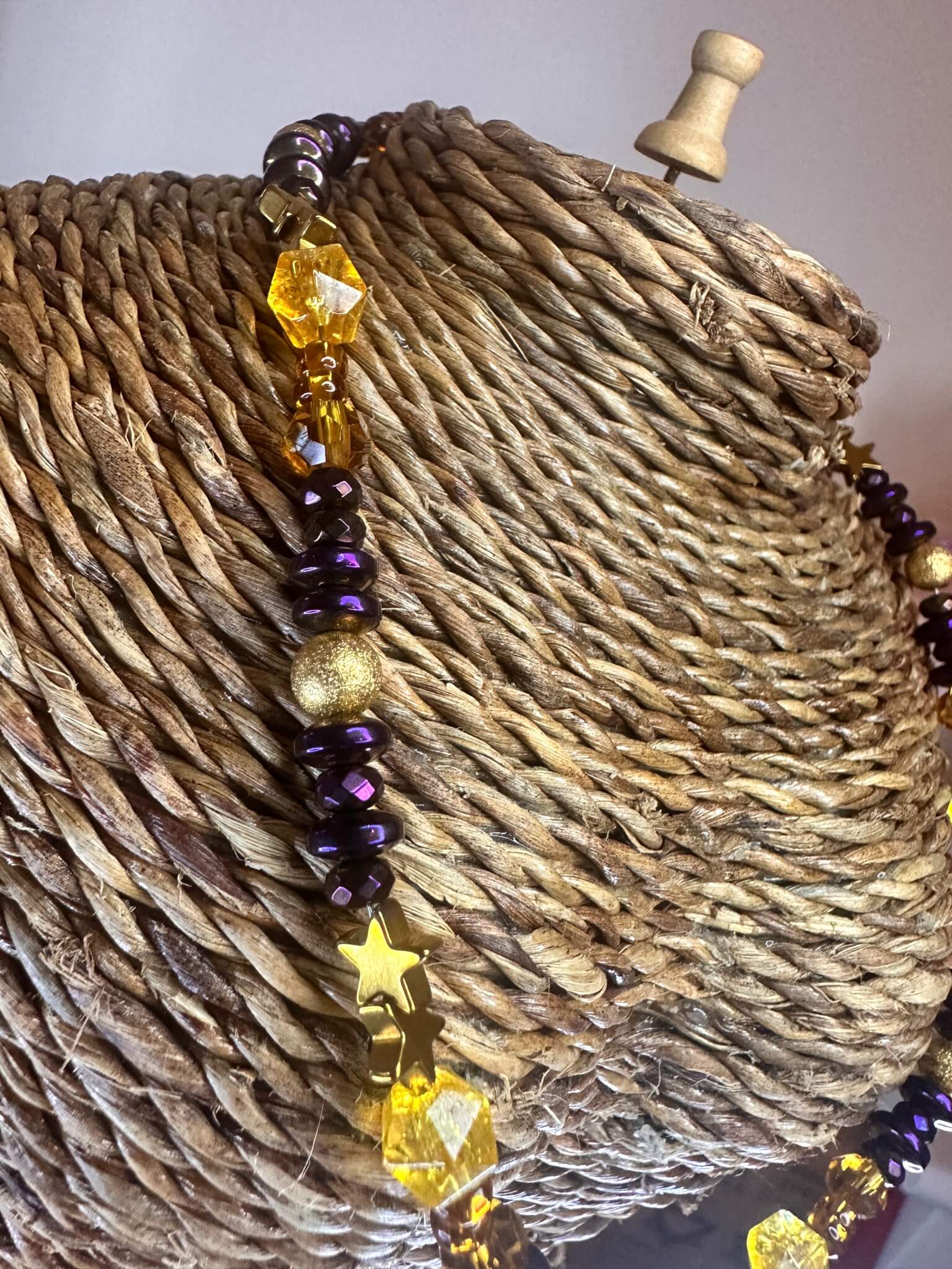 "Close-up side detail of the Radiant Harmony Citrine and Hematite collar necklace on display."