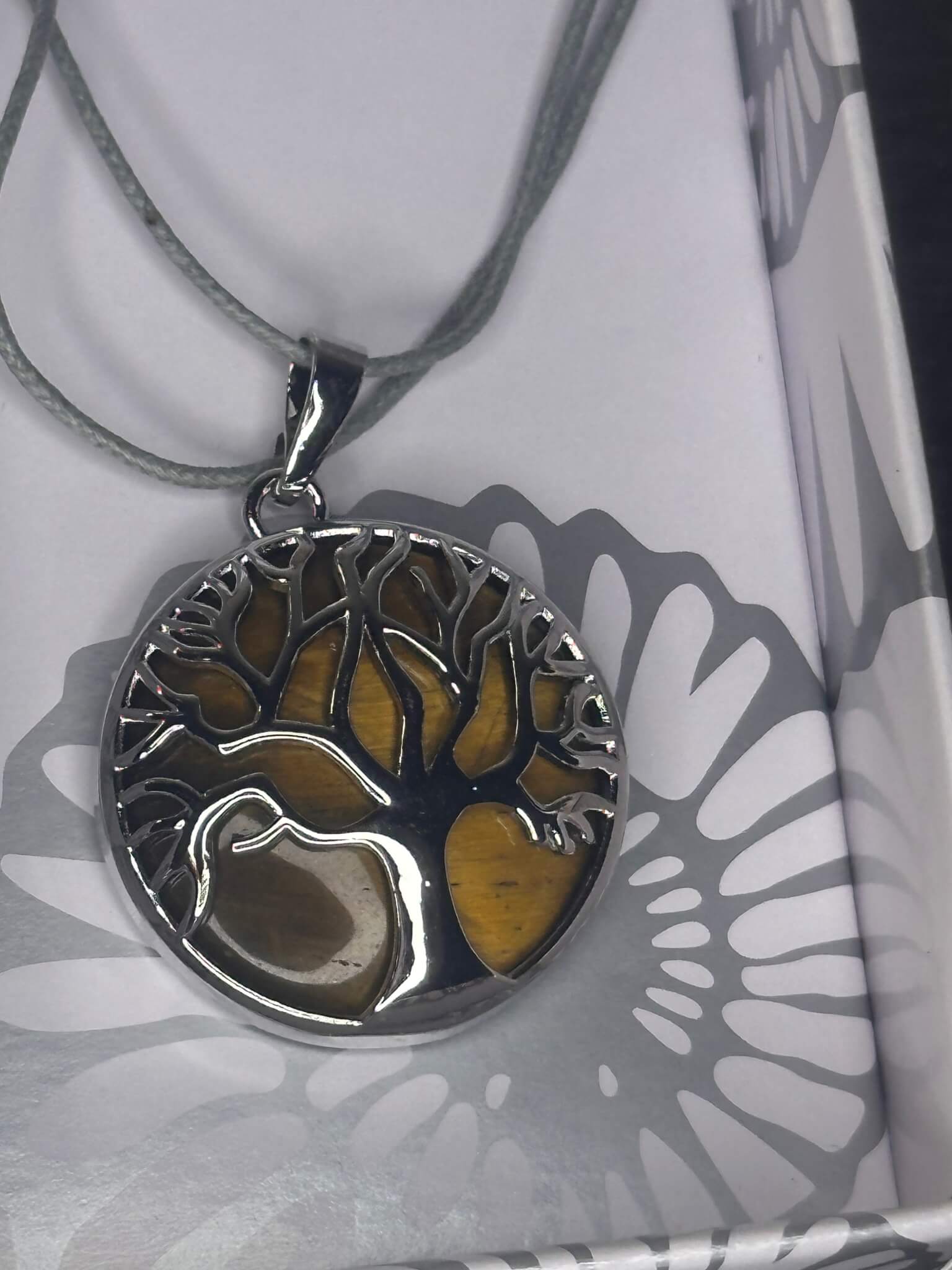 “✨ Chrome-plated chakra pendant with Tree of Life design and gemstone”