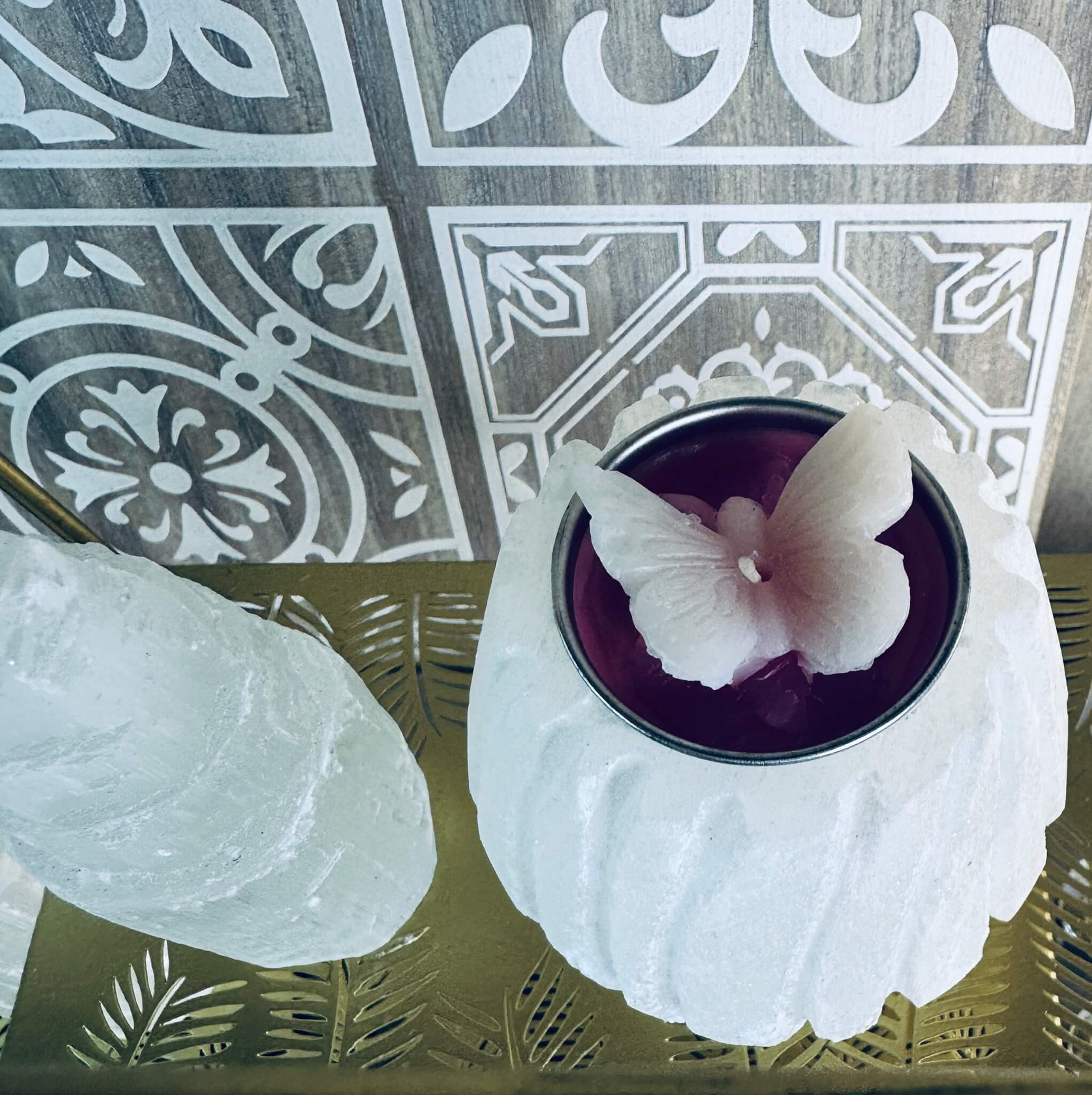 Selenite tealight candle holder glowing with soft spiritual light