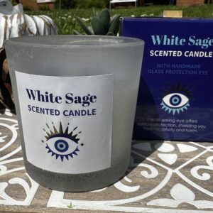 White sage scented candle with handmade blue glass evil eye charm designed for spiritual cleansing, protection and calming ritual spaces.